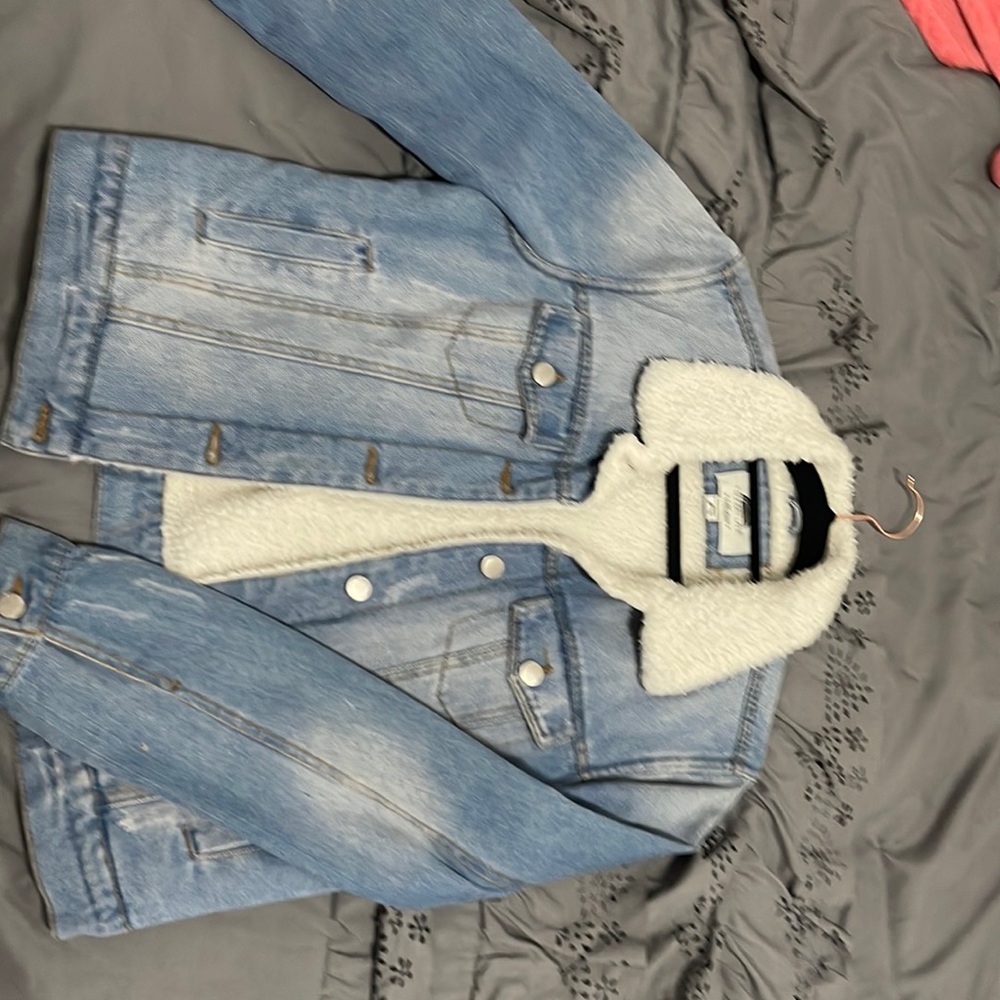 Medium wash denim jacket with white furry lining